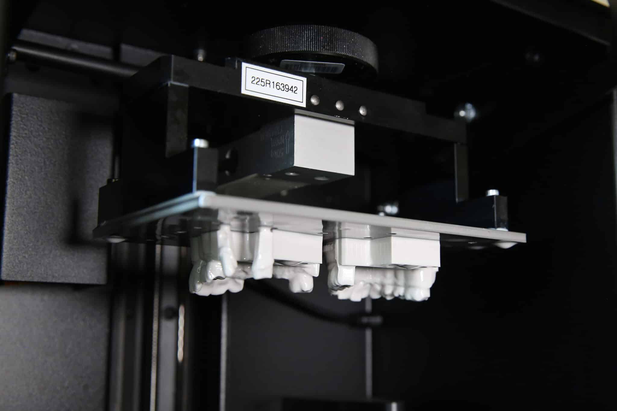 3D Dental Printing Highly accurate dental restorations being fabricated inside Innova Dental's state-of-the-art 3D printing system during the digital manufacturing process.