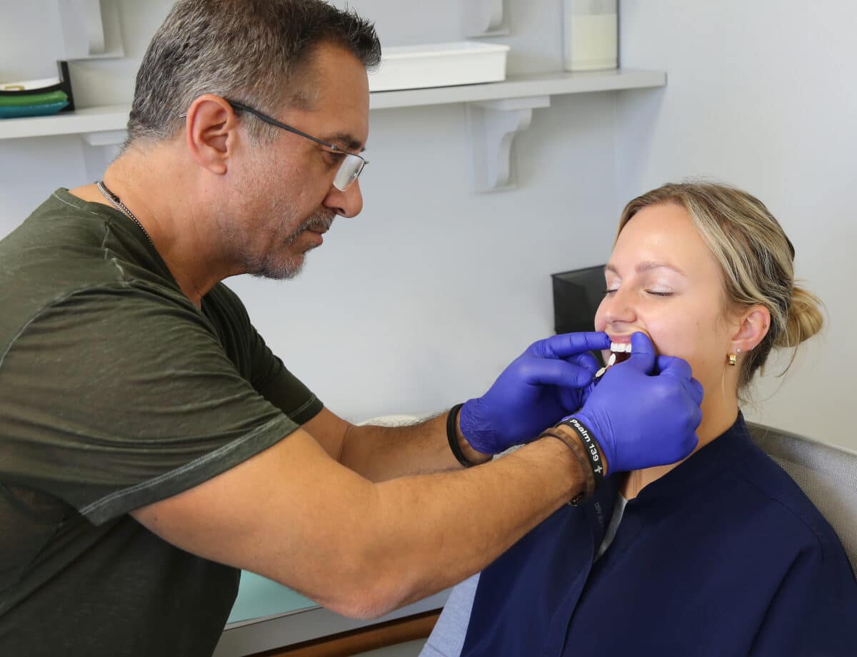 John Sanchez, Innova Dental's Lead Technician, performing a personalized patient consultation to ensure precise fit and aesthetic harmony for dental restorations.