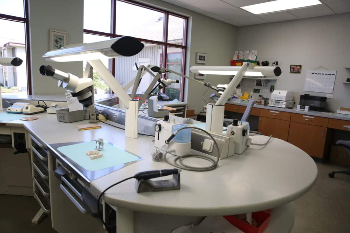 Interior view of the Innova Dental lab workstation, featuring advanced microscopes and precision equipment for crafting custom dental restorations.