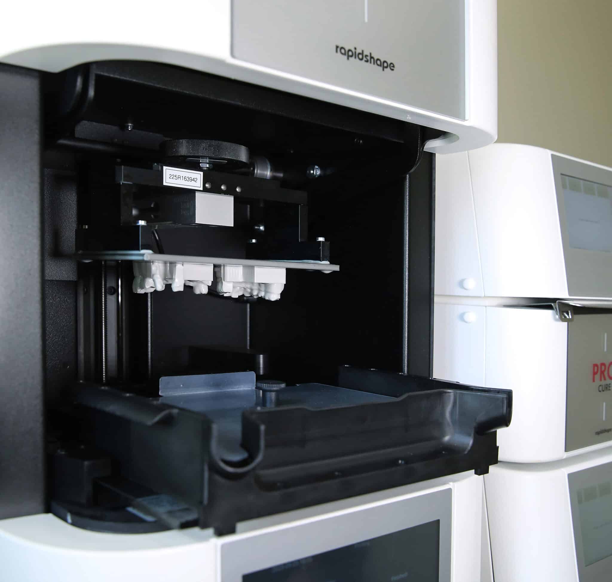 Close-up of Innova Dental's advanced 3D printing system, a core component of our digital workflow for highly accurate dental restorations.